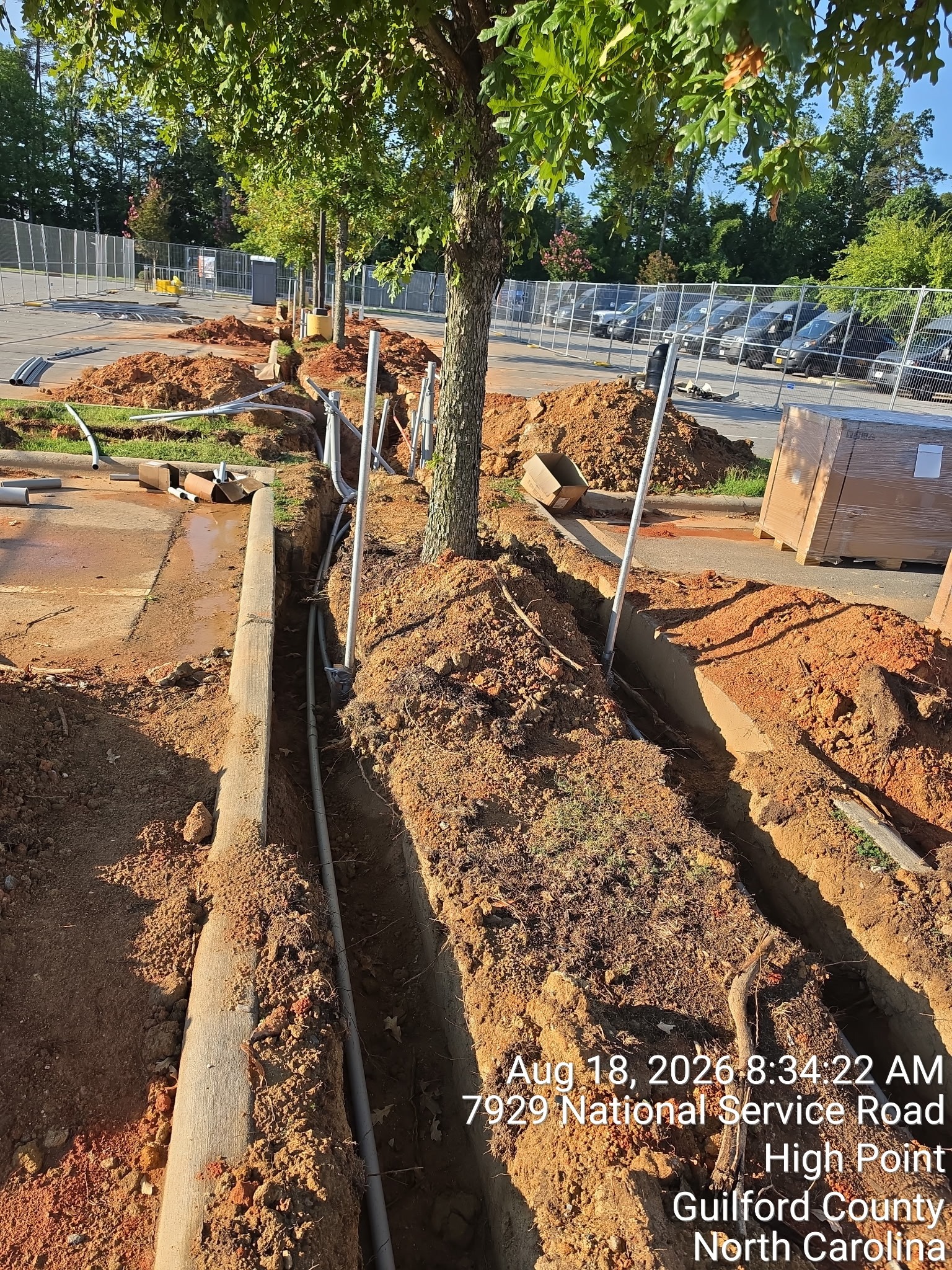 Underground electrical raceways being installed for a North Carolina EV charging project