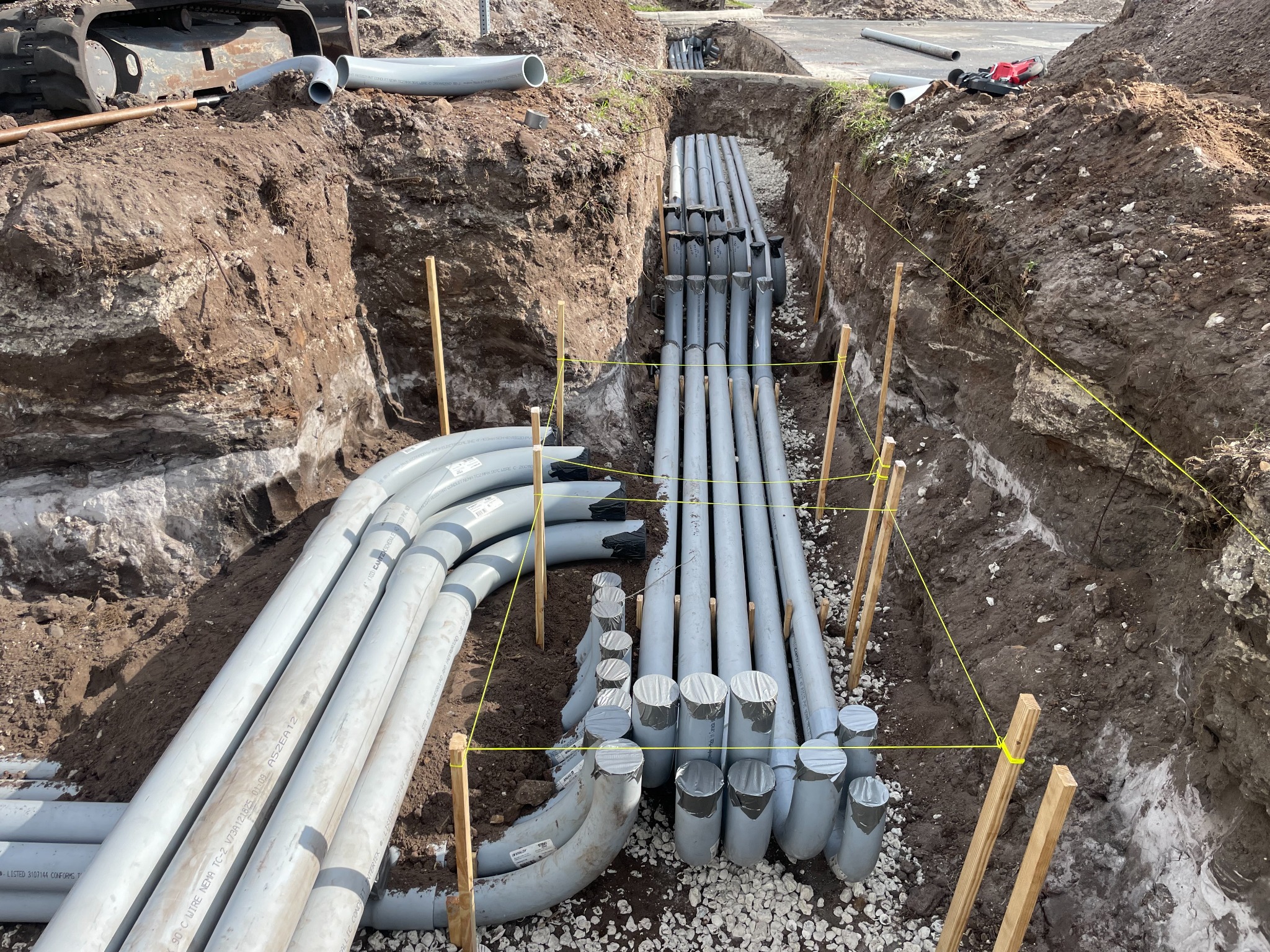 Multiple underground electrical conduits routed through a Florida EV charging site